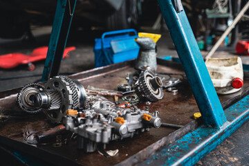 In a garage full of disassembled engine parts.