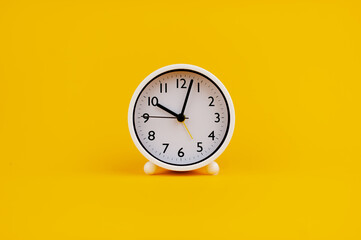 white clock on yellow background concept of time Time planning