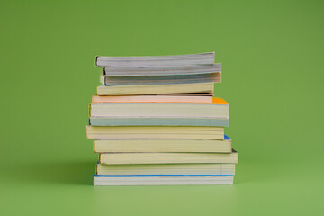Books. Stack of books stacked on light green background. Reading. Reading concept. and collection of books