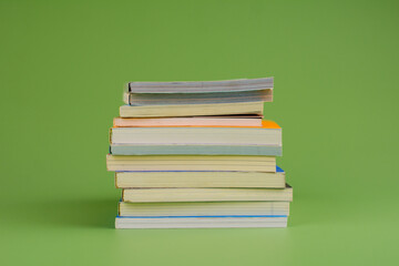 Books. Stack of books stacked on light green background. Reading. Reading concept. and collection of books