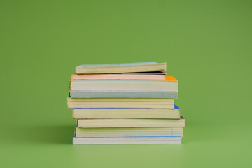 Books. Stack of books stacked on light green background. Reading. Reading concept. and collection of books