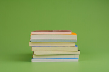 Books. Stack of books stacked on light green background. Reading. Reading concept. and collection of books