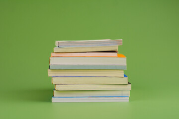 Books. Stack of books stacked on light green background. Reading. Reading concept. and collection of books