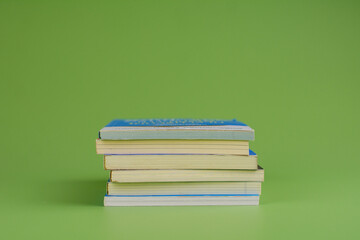 Books. Stack of books stacked on light green background. Reading. Reading concept. and collection of books