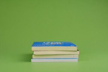 Books. Stack of books stacked on light green background. Reading. Reading concept. and collection of books