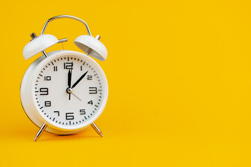 white clock on yellow background concept of time time is important to work