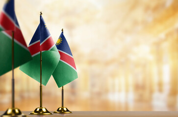 Small flags of the Namibia on an abstract blurry background