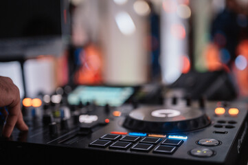 Obraz na płótnie Canvas DJ Spinning. mixing and scratching in a night club. DJ playing music at mixer. Closeup. Party.