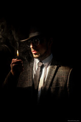 photo shoot, men's photo shoot, black background, smokes, dark photo, man in a hat