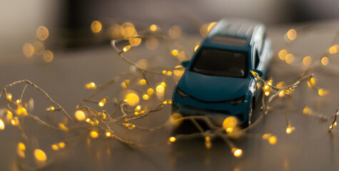 Obraz na płótnie Canvas Miniature Car on colorful bokeh background. Holiday Merry Christmas concept.
