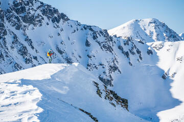 Mountaineer backcountry ski walking ski alpinist in the mountains. Ski touring in alpine landscape...