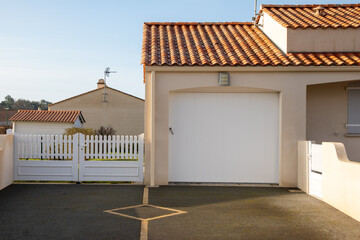 modern private facade entrance house suburb with garage white gate overhead door pvc car entrance