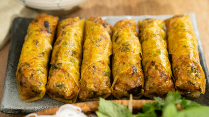 Capture the essence of Vietnamese cuisine with our stunning stock photo of fried spring rolls! This high-quality image features a beautifully arranged plate of golden brown spring rolls, garnished wit
