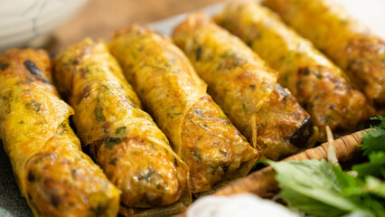 Capture the essence of Vietnamese cuisine with our stunning stock photo of fried spring rolls! This high-quality image features a beautifully arranged plate of golden brown spring rolls, garnished wit