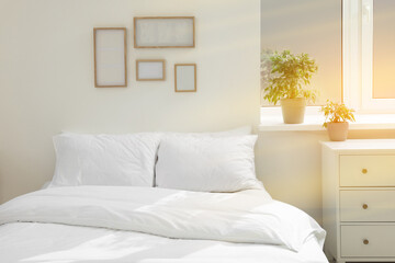 White soft pillows on cozy bed in room