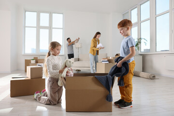 Happy family settling into new house and unpacking boxes. Moving day