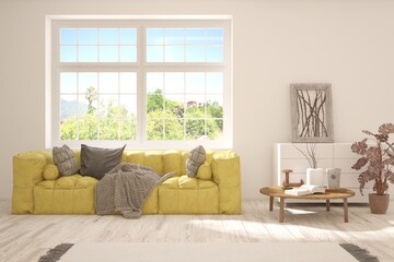Fototapeta premium White living room with sofa and summer landscape in window. Scandinavian interior design. 3D illustration