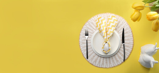 Festive Easter table setting with bunny ears made of egg and napkin on yellow background, flat lay. Banner design with space for text