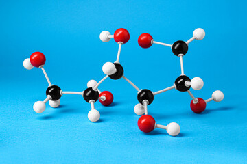 Obraz premium Molecule of glucose on light blue background. Chemical model