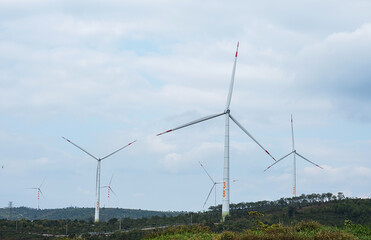 Wind generator turbines at wind farm. Alternative energy concept.