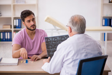 Young male patient visiting old male doctor radiologist