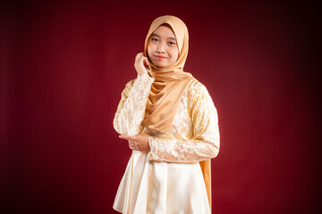 Portrait of a beautiful Asian Muslim female model wearing hijabwear with at a studio photoshoot. Modern hijab fashion and beauty concept