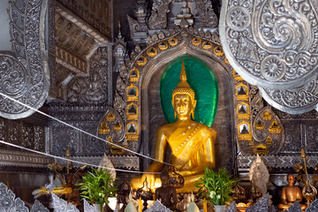 Fototapeta premium golden buddha with gold engraved metal background Seeing as the highlight