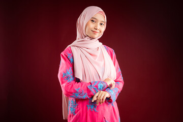 Portrait of a beautiful Asian Muslim female model wearing hijabwear with at a studio photoshoot. Modern hijab fashion and beauty concept