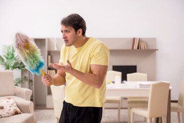 Young man doing housework indoors