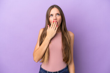 Fototapeta premium Young Lithuanian woman isolated on purple background yawning and covering wide open mouth with hand