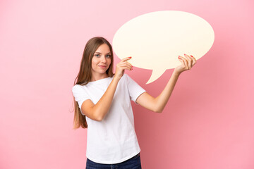 Young Lithuanian woman isolated on pink background holding an empty speech bubble