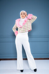 Portrait of a beautiful Asian Muslim female model wearing hijabwear with at a studio photoshoot. Modern hijab fashion and beauty concept
