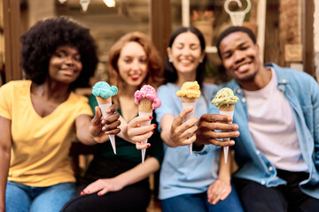 Variety of ice creams on the hands of multiethnic people