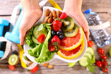 health food- hand holding plate with fruit and vegetable