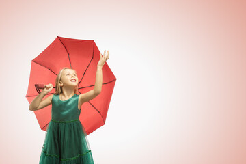  dreaming beautiful little girl with with umbrella on color background. panoramic banner with copy space.
