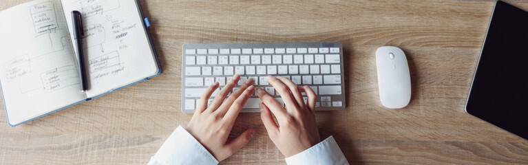 Close up of business woman hands working using keyboard of computer in office workplace