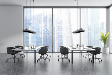 Business interior with workplace and laptop, panoramic window on city view