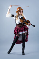 Obraz premium Country girl with violin on the grey background.
