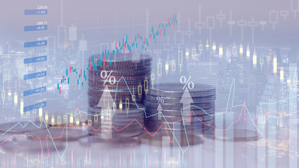 Silver coins with financial investment concept graphs are used for background.