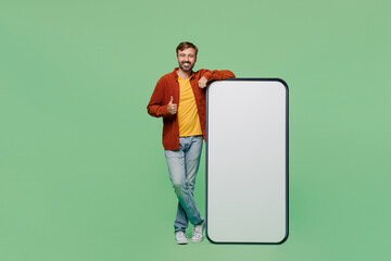 Full body elderly man 40s years old he wear casual clothes red shirt t-shirt big huge blank screen mobile cell phone smartphone with area show thumb up isolated on plain pastel light green background