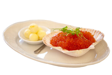 Red caviar in a clam shell on a white plate. Salmon caviar. Buffet appetizer. Isolated