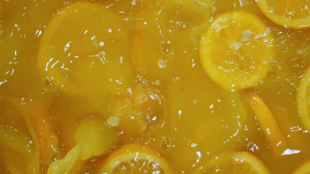 Orange wedge sinking into a pool of juice