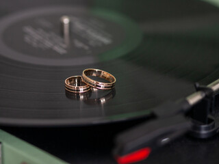 Closeup wedding rings of bride and groom on gramophone 