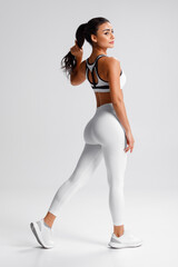 Fitness woman. Athletic girl on the gray background - 582668414