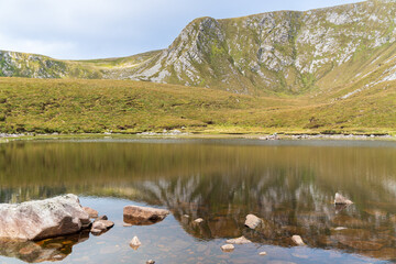 Stunning Corrymore lake reflections on a summer day. Lough Accorrymore in Croaghaun Mountains on...