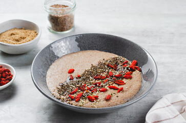Flaxseed Porridge in a Bowl, Healthy Breakfast or Snack, Porridge Decorated with Chia Seeds and Goji Berries