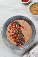 Flaxseed Porridge in a Bowl, Healthy Breakfast or Snack, Porridge Decorated with Chia Seeds and Goji Berries