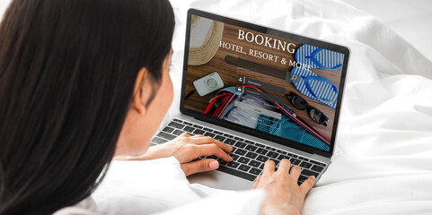 Portrait of woman use technology of laptop computer for hotel and resort booking online summer holiday travel system plan searching information weekend vacation trip.reservation online travel concept
