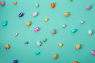 Small chocolate Easter eggs flowers holiday background