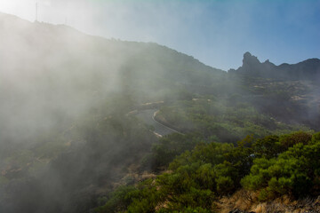 Fototapeta na wymiar Fog in the mountains with road on Tenerife in Spain